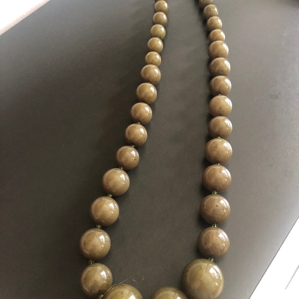 Vintage necklace. 32” long. Length when wearing is 16”. Olive green.